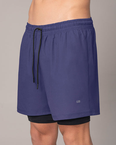 Pantaloneta deportiva con bolsillo lateral con bóxer interno#color_522-estampado-camuflado-azul