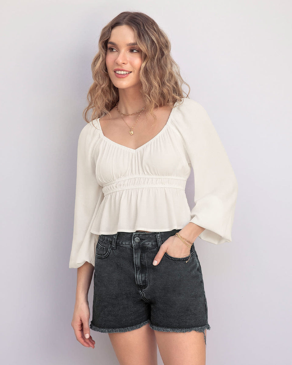 Blusa manga larga con elástico en escote